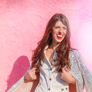 A girl in front of a pink wall