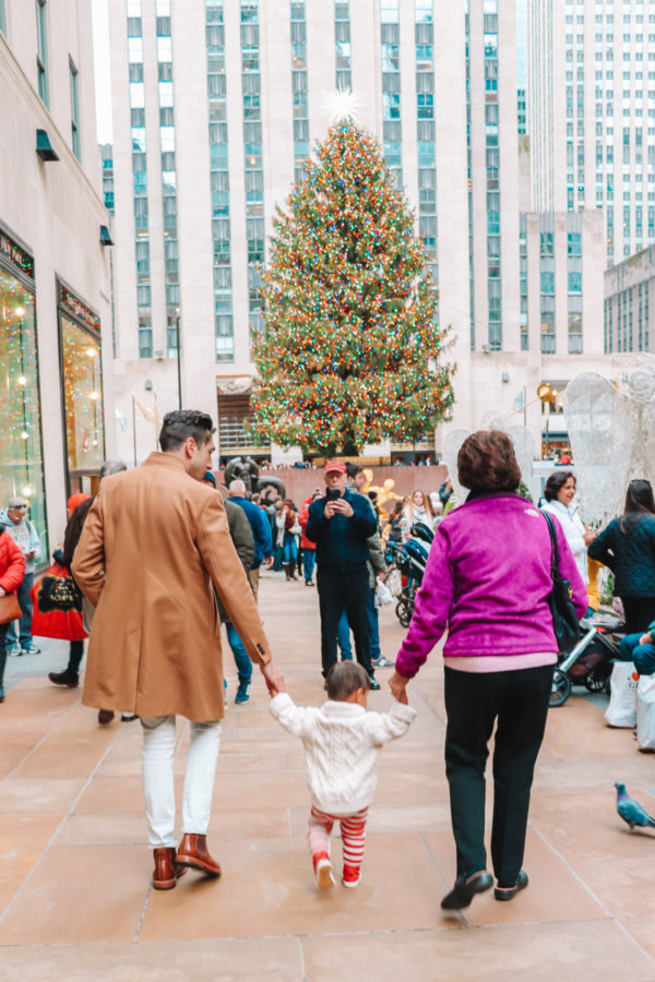 A group of people walking on a sidewalk