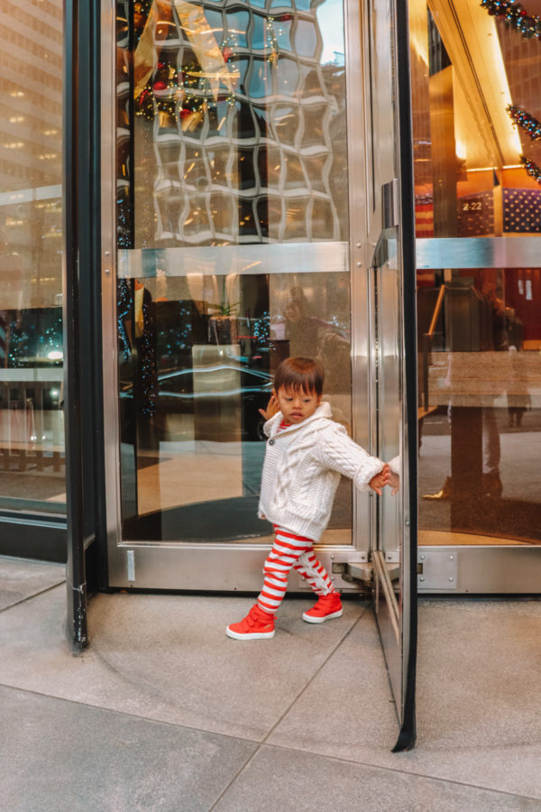 A person standing in front of a store window