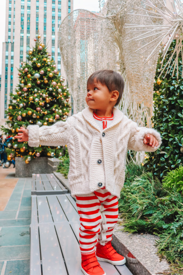 A little boy standing on a bench