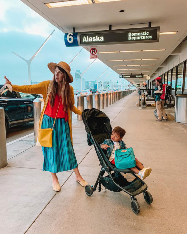 A group of people standing around at an airport