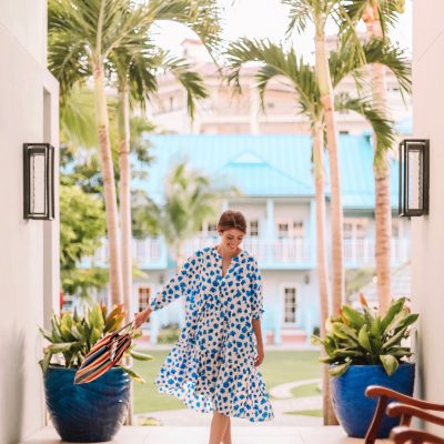 A person standing next to a palm tree