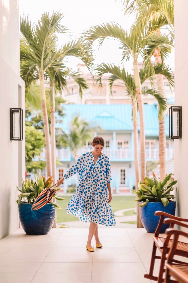 A person standing next to a palm tree