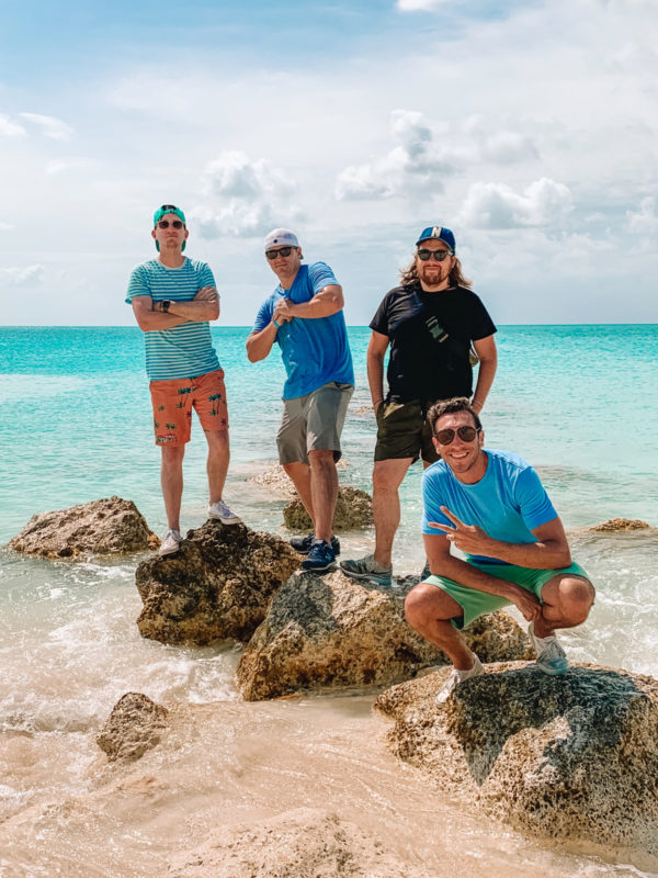 A group of people standing next to a body of water