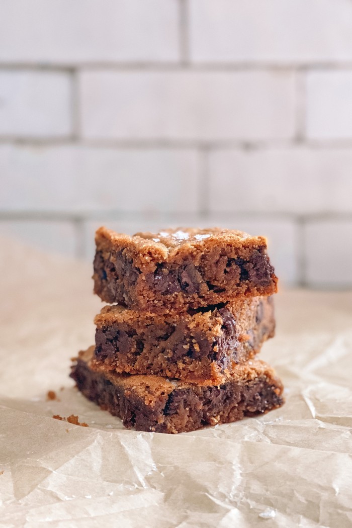 chocolate chip cookie bars stacked on parchment paper