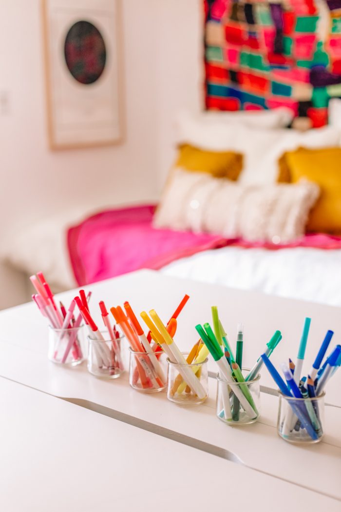 Pens organized in rainbow order in a home office