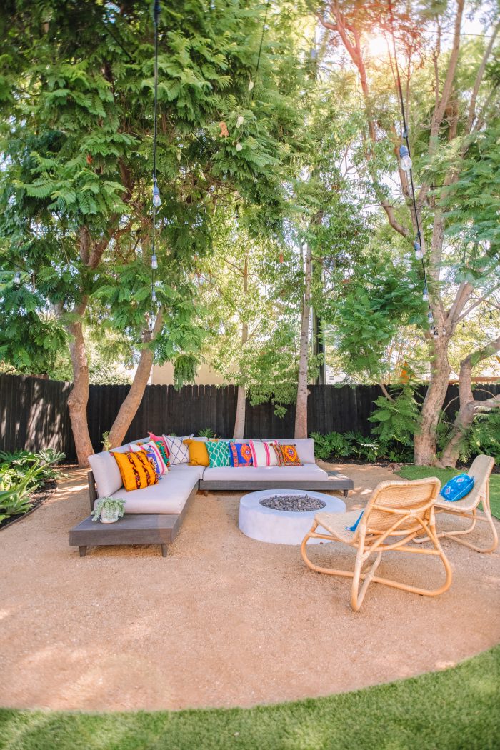 A fire pit with an outdoor couch and chairs