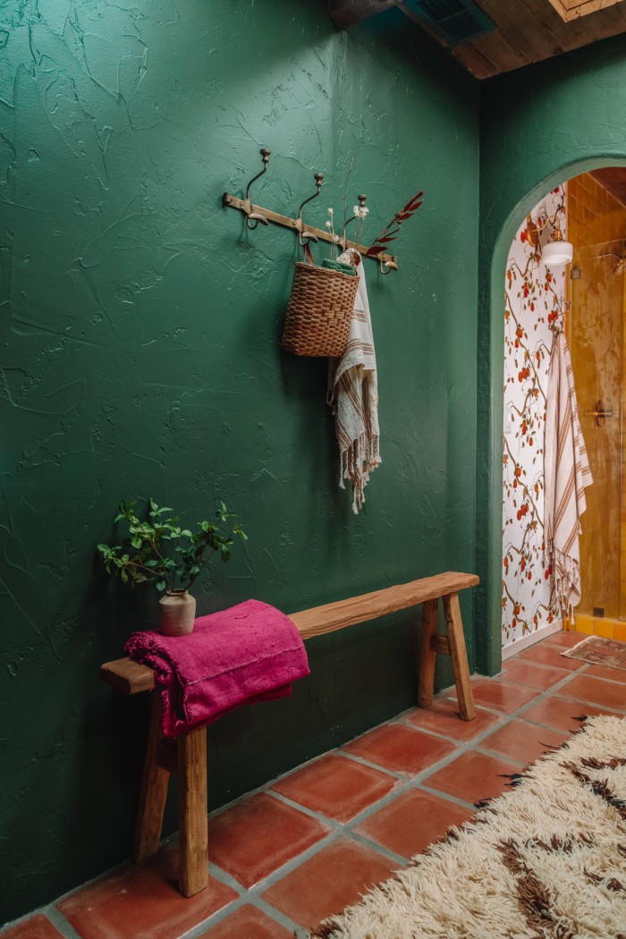 dark green wall with narrow bench