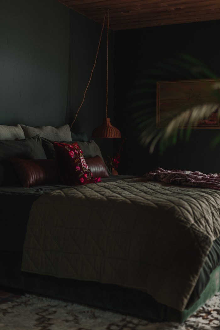 green bed in dark green bedroom