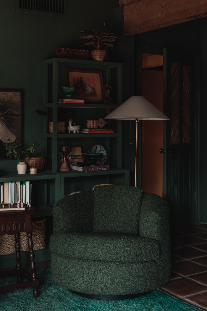 green chair in dark green room