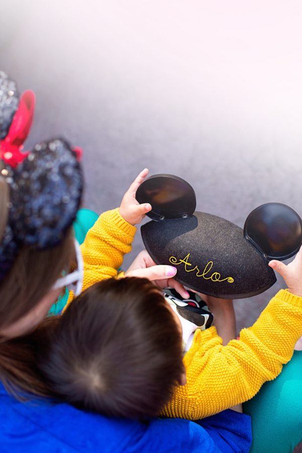 A little boy wearing a mickey hat