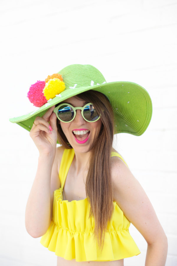 A woman wearing a hat and sunglasses