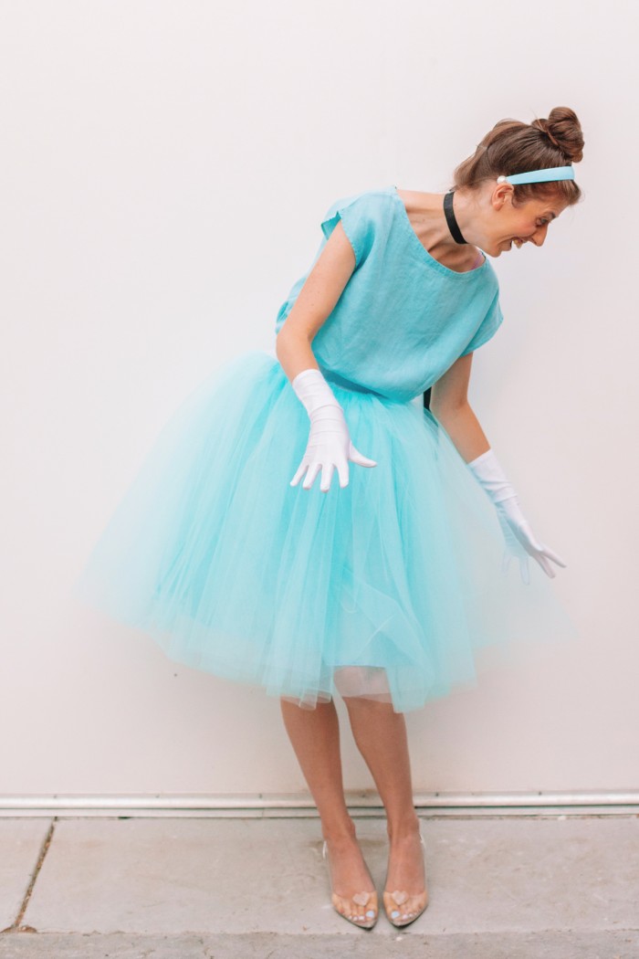 Woman in Cinderella costume in front of white wall