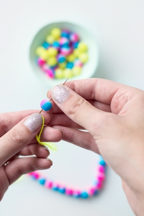 Someone making a friendship bracelet