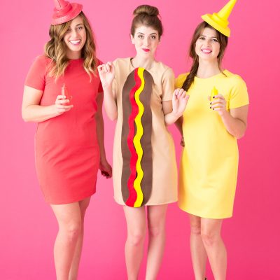 Three people dressed as a hot dog, ketchup, and mustard 