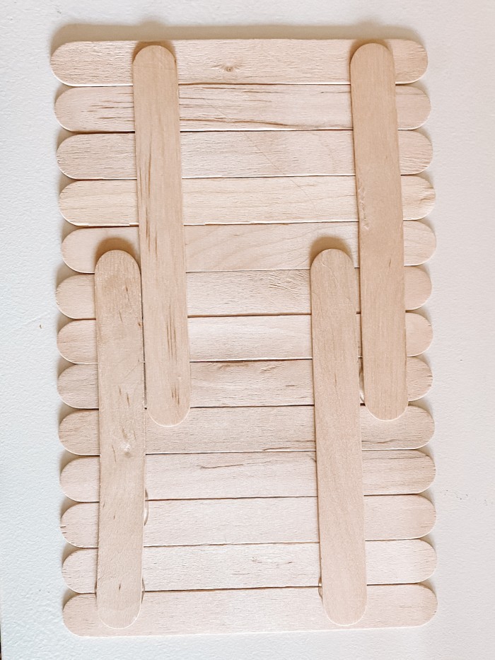 Popsicle sticks glued together on a white table