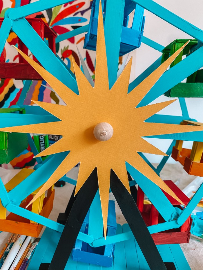 Yellow starburst on a teal popsicle stick ferris wheel