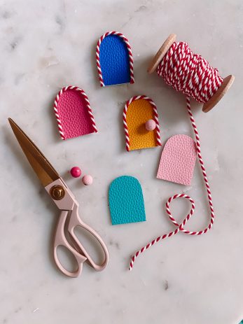 Tiny colorful doors with string around them