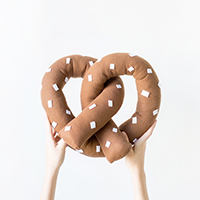 Someone holding a pretzel pillow