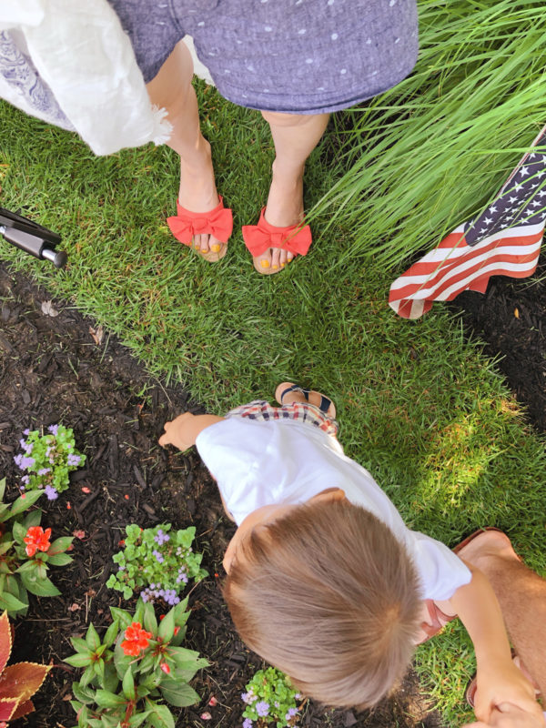 A little boy that is standing in the grass