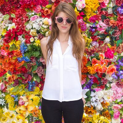 A woman standing in front of flowers