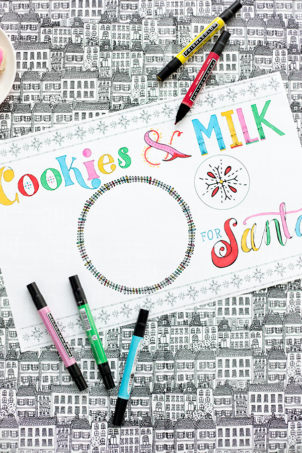 A place mat that says \"cookies and milk\" with bowls on it