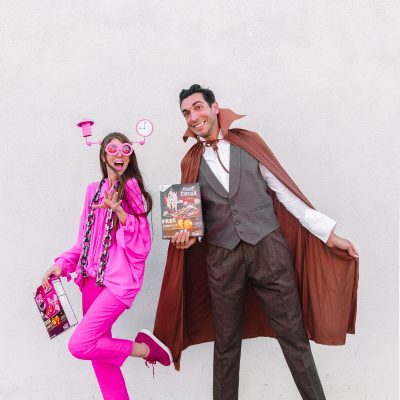 A man and a woman posing and wearing a costume