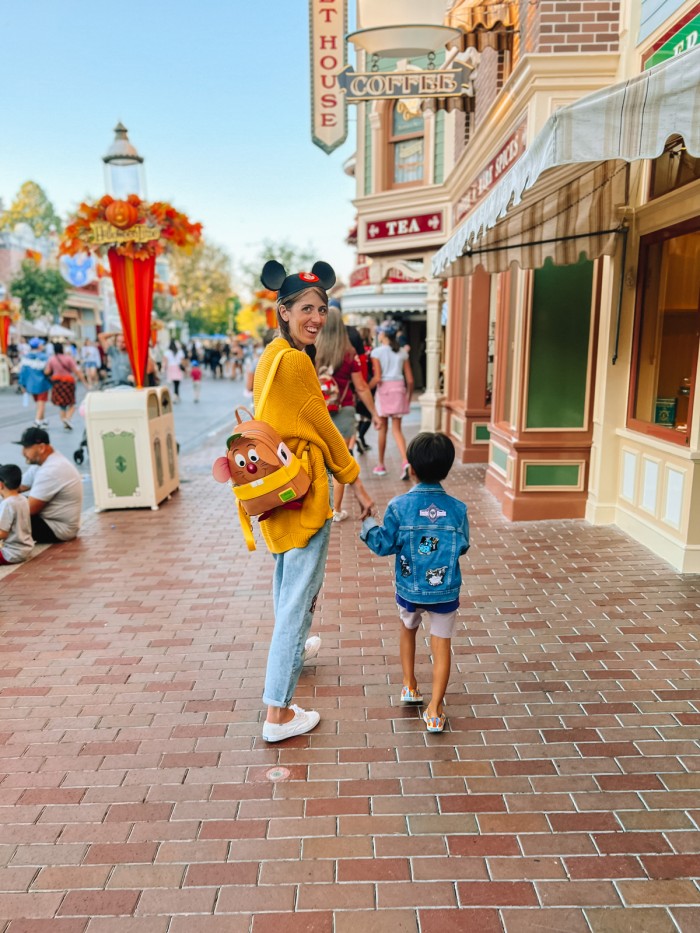 Mom and son walking down Main Street at Disneyland Halloween Time