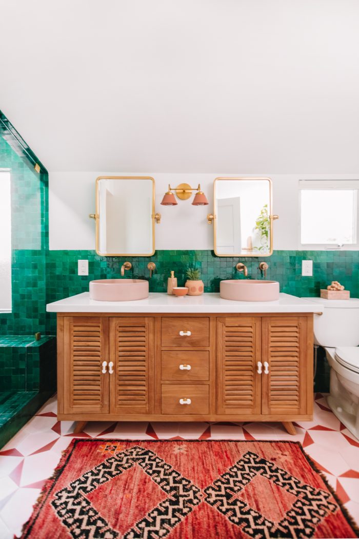 A bathroom with two sinks and two mirrors