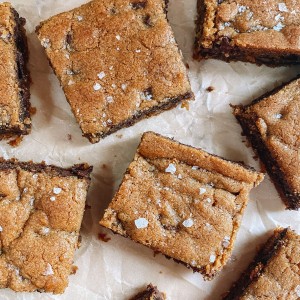 chocolate chip cookie bars on parchment paper with flaked salt on top