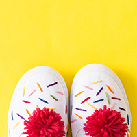 Sneakers with red pom poms