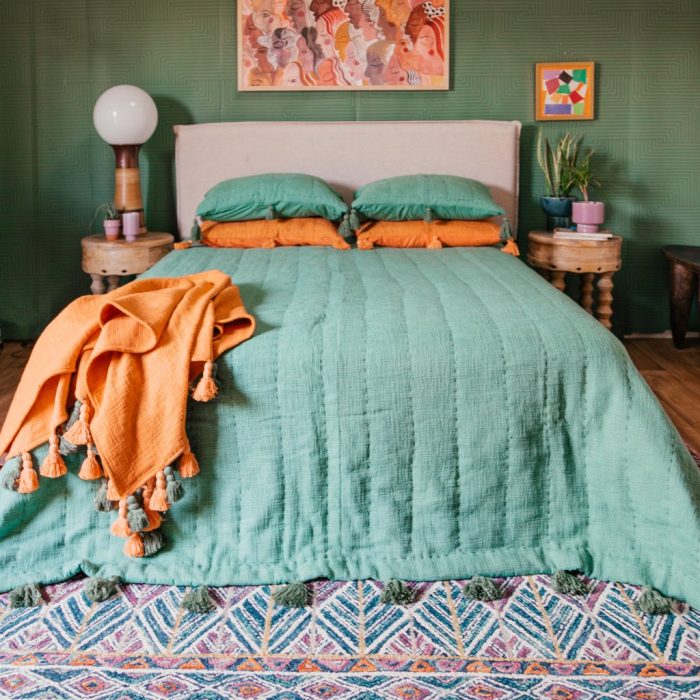 A bed with a colorful blanket