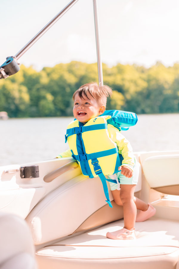 A little boy sitting on a boat