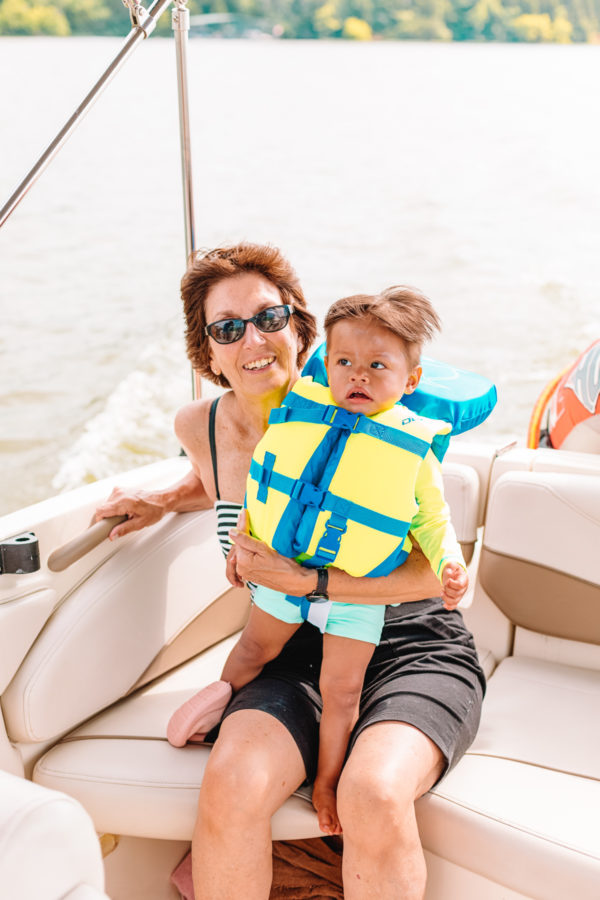 A small child sitting on a boat in the water