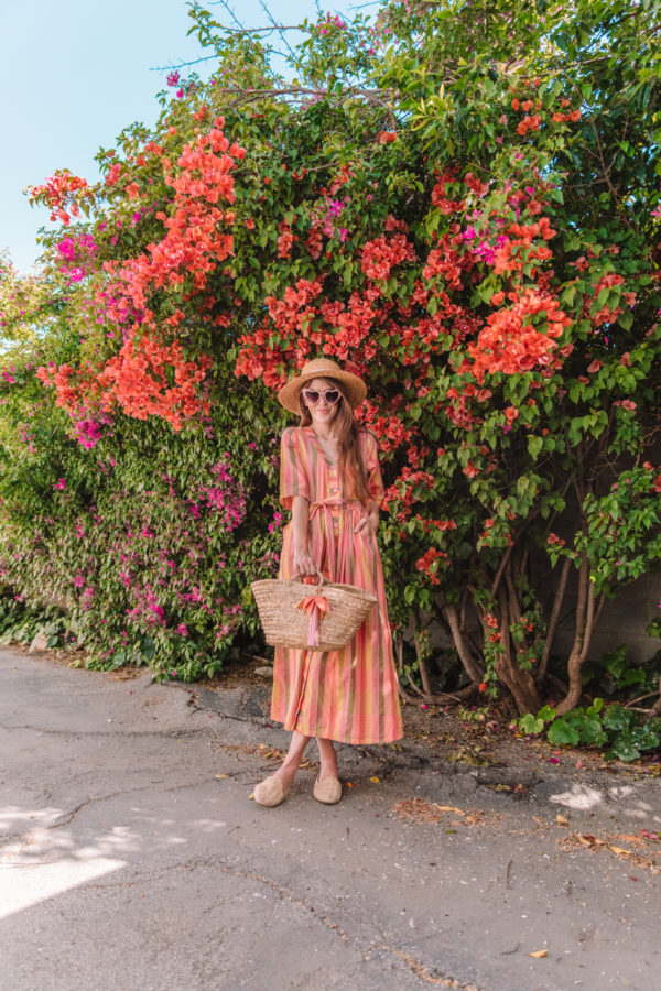 A woman standing in front of flowers