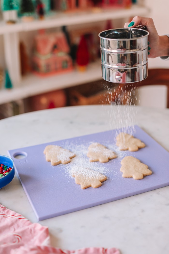 Cookies being dusted with powdered sugar