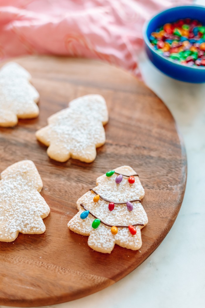 Tree cookie with chocolate Christmas lights on wood board