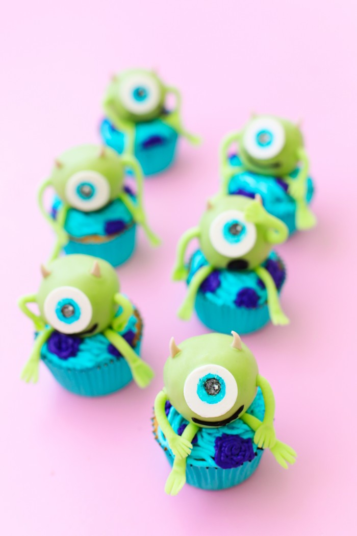 Mike Wazowski cake balls on top of cupcakes