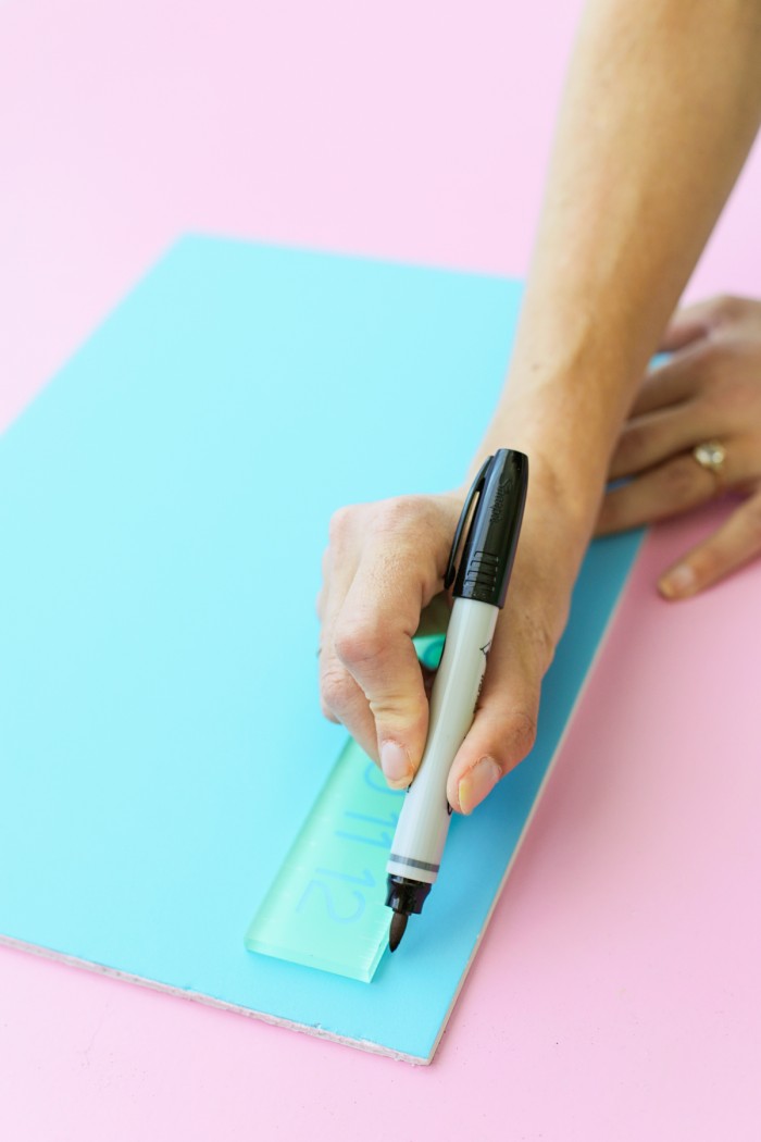 Drawing a line on a foam core door decoration with a black permanent marker