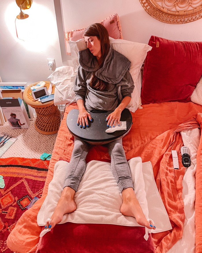 Woman asleep in pink bed