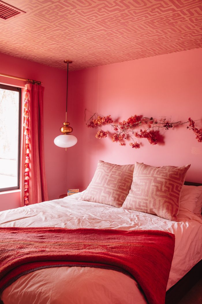 Pink room with pink patterned ceiling and pink bedding