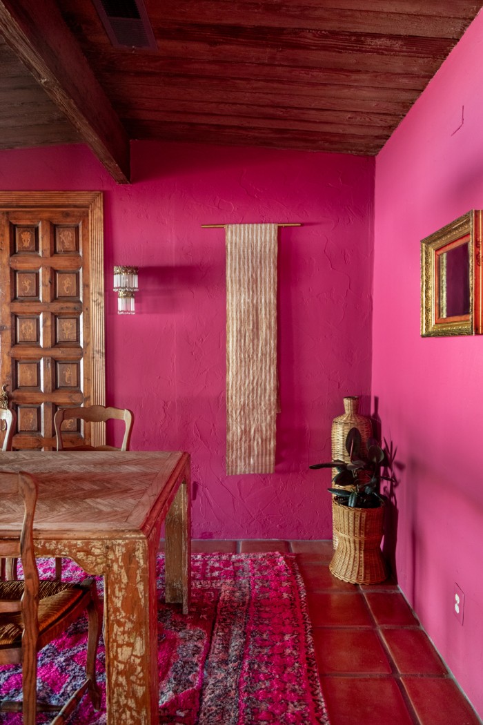 striped table runner as tapestry on pink wall