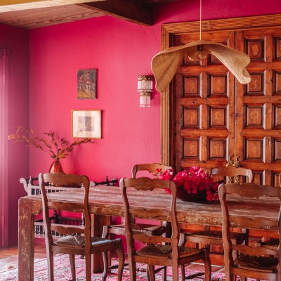 pink dining room with wood table and chairs