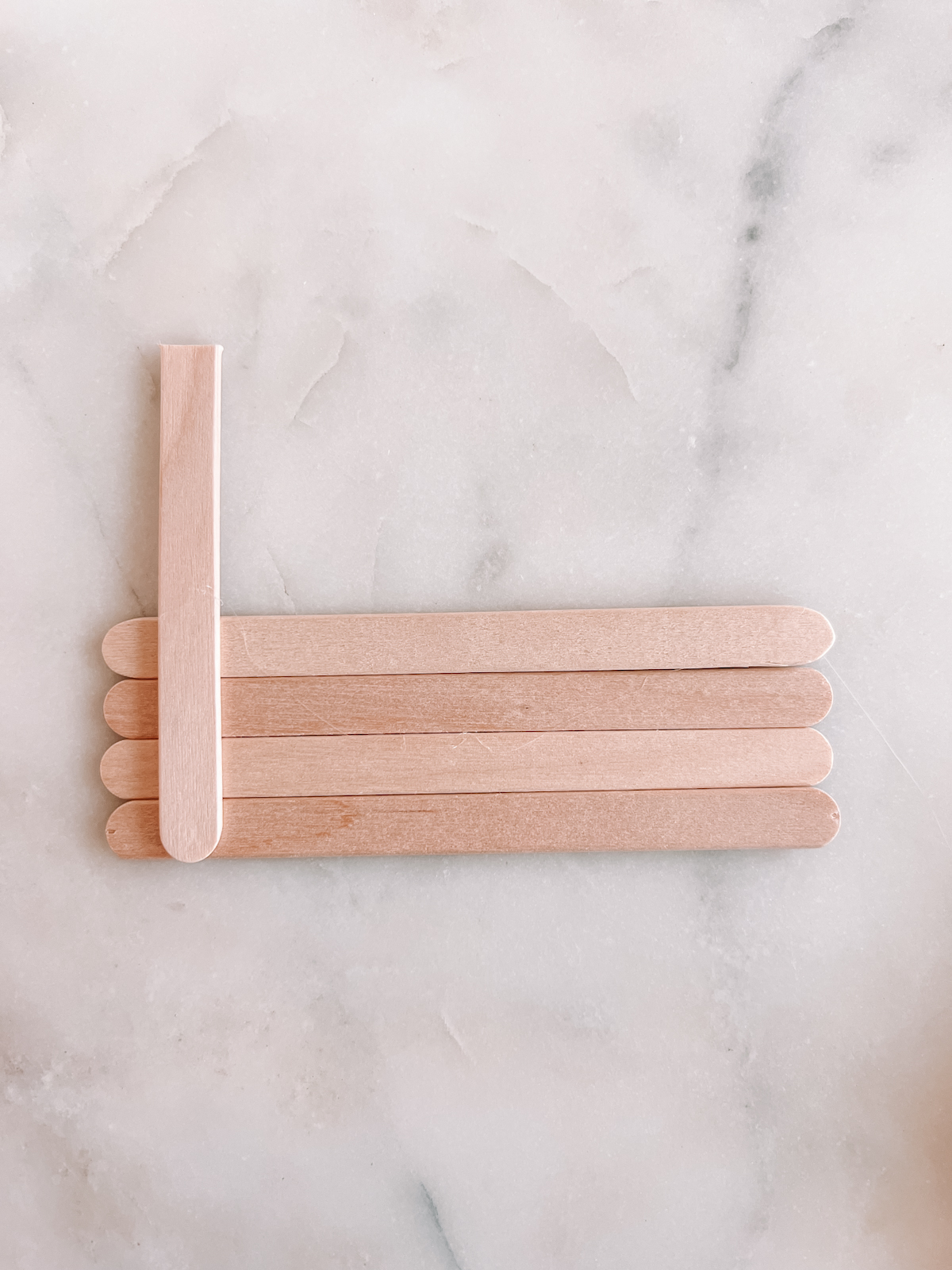 popsicle sticks on marble table