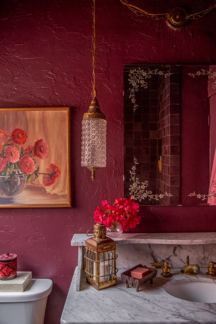 hanging crystal light in purple bathroom