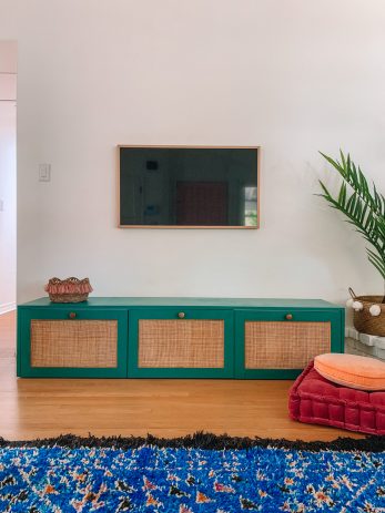 A living room with a TV and turquoise table