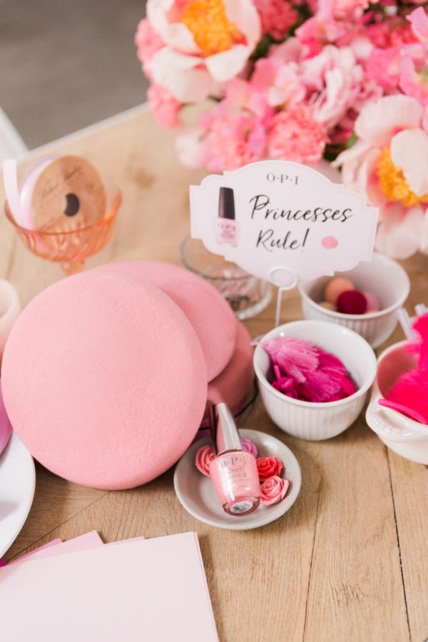 A table with flowers and nail polish