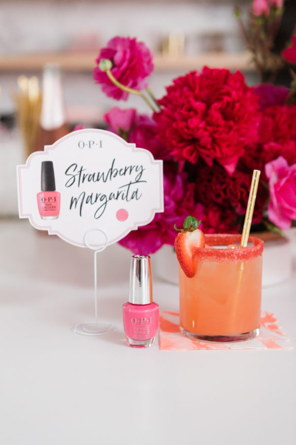 Pink drink next to nail polish