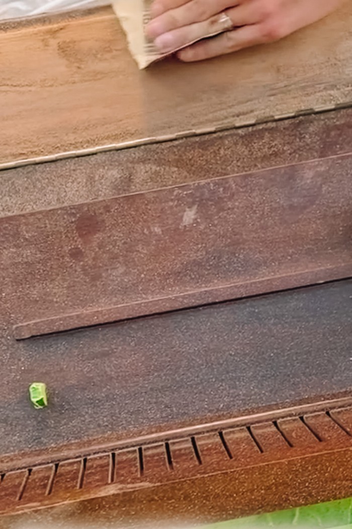 Sanding a wood piano