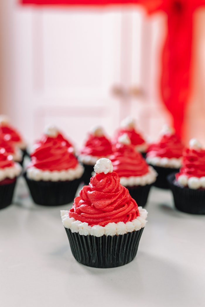 Multiple santa hat cupcakes on a table